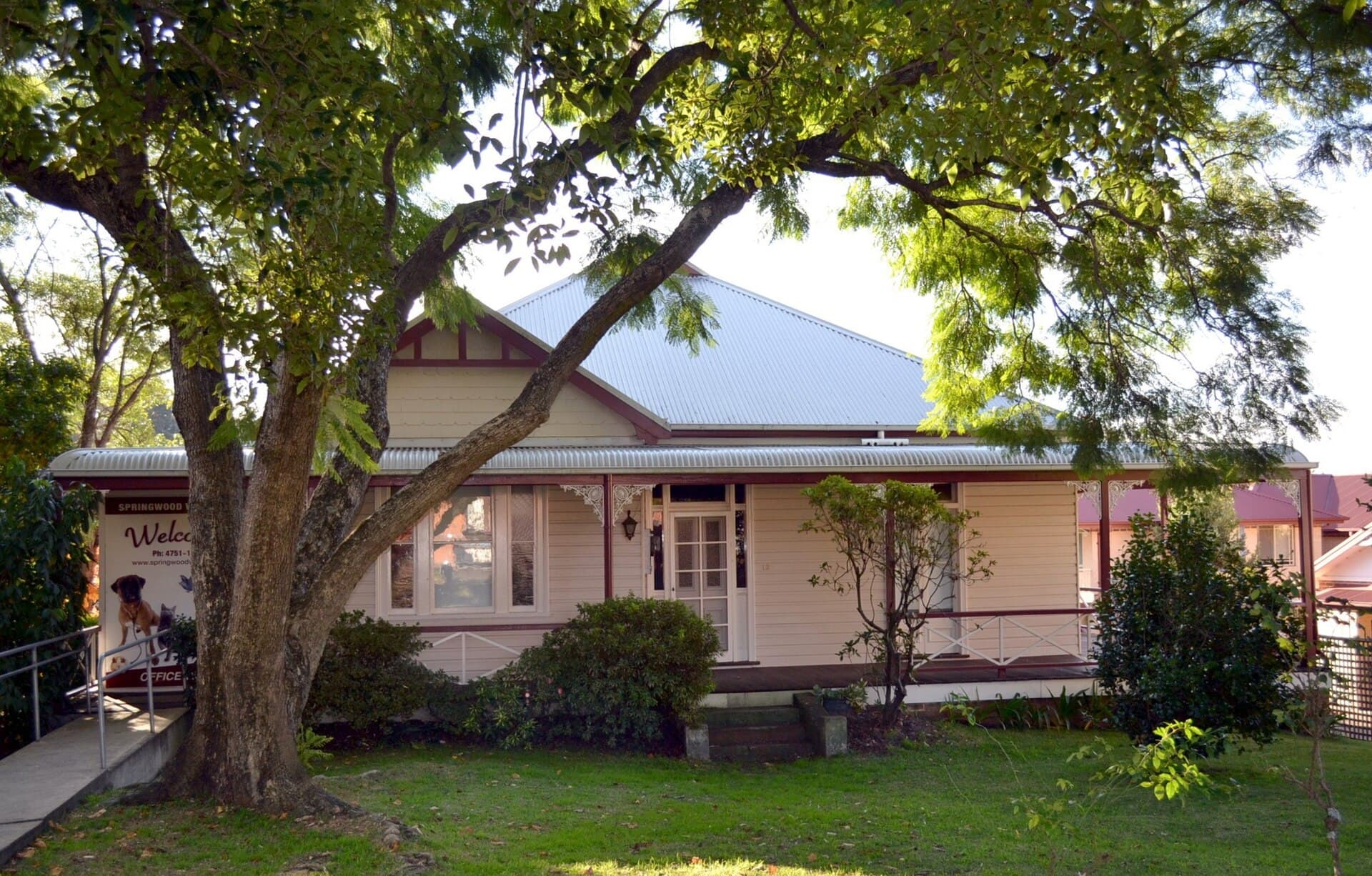A small weatherboard cottage in the Blue Mountains, New South Wales, with a corrugated roof and timber verandah.