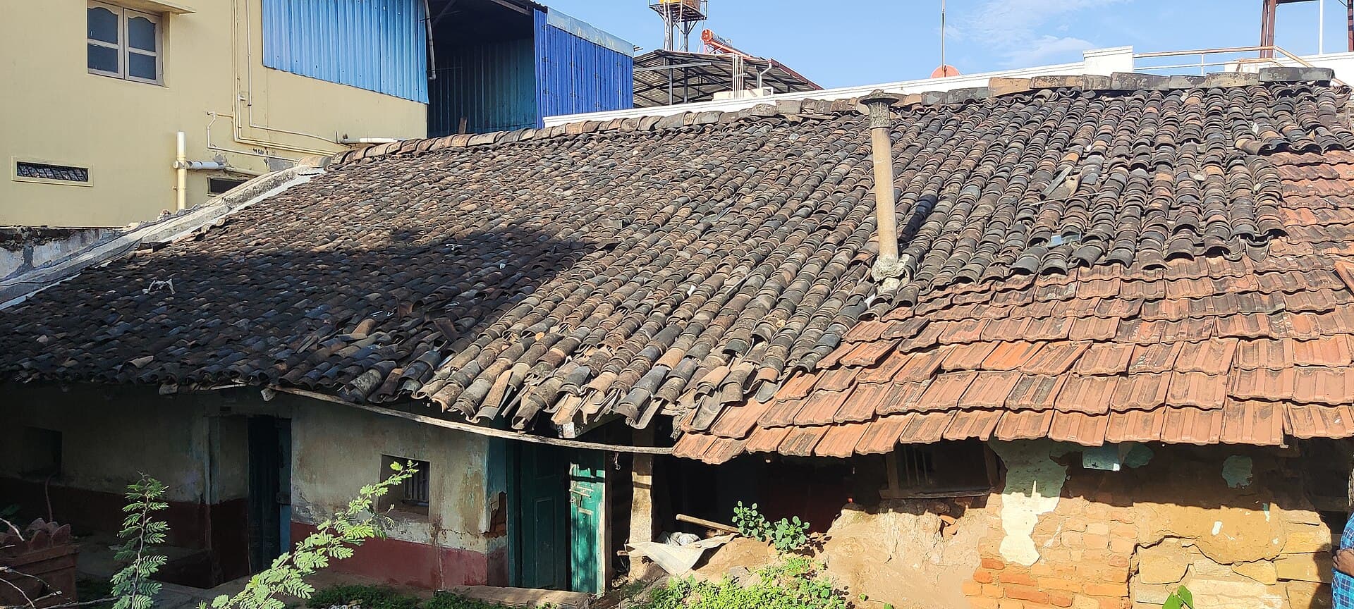 Weathered terracotta roof tiles, the kind of clay-tile roof still common on older Australian houses.